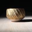 Woodfired in a sagger, using copper glaze. Electric fired with gold lustre<br>H 7cm D 10cm